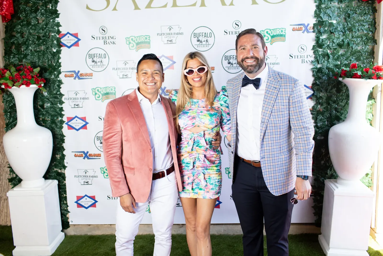 Guests on the red carpet in front of the Sazerac backdrop