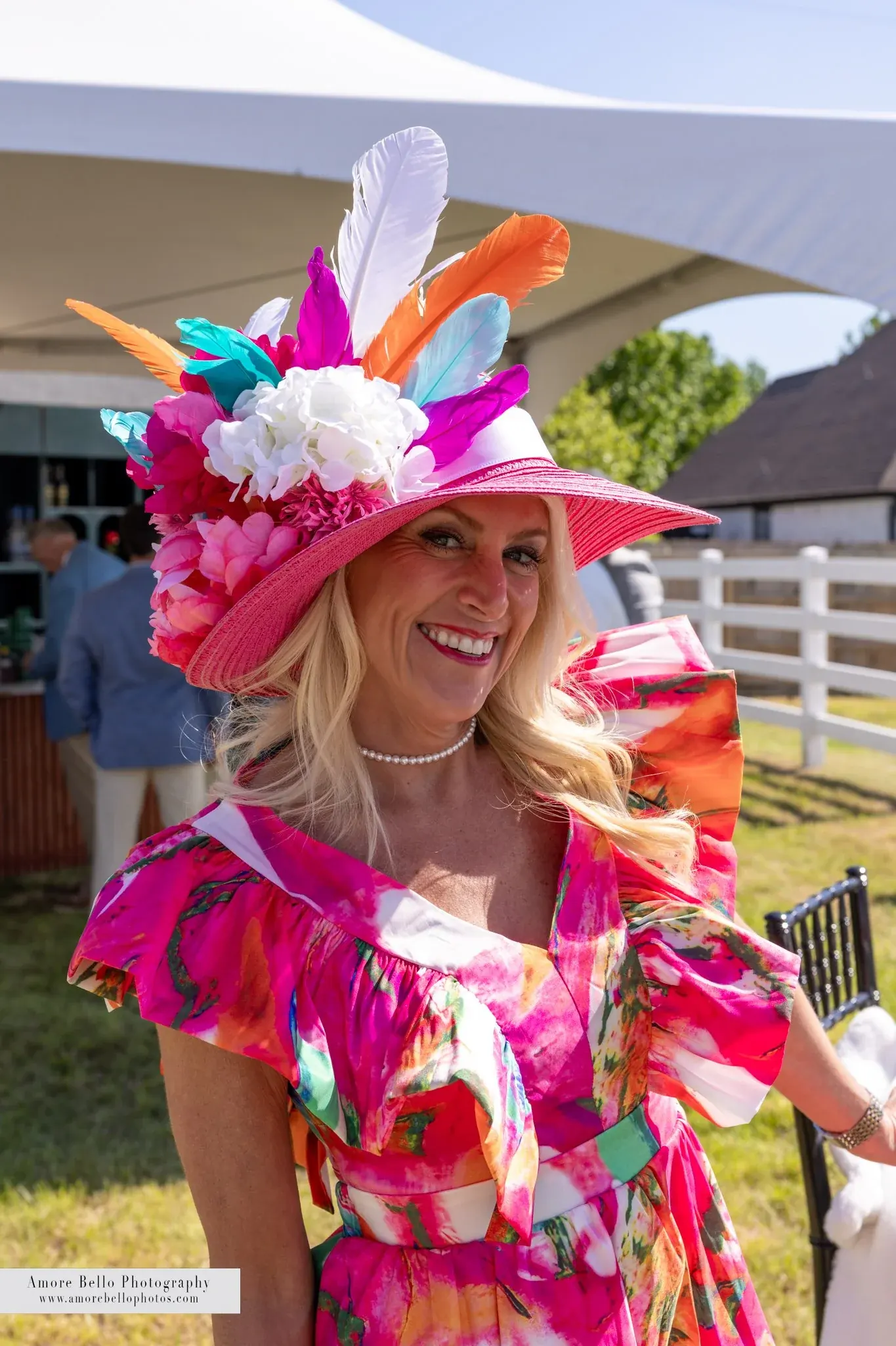 A guest in a bright floral Derby hat